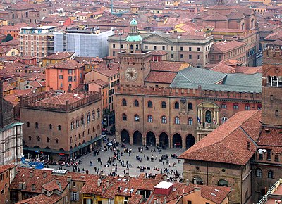 What term was first coined at the University of Bologna to describe the corporations of students and masters?