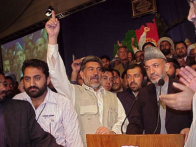 What type of hat is Hamid Karzai famously known for wearing?