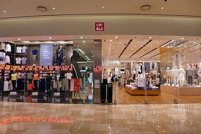 In which year did Uniqlo open its first store outside of Japan?