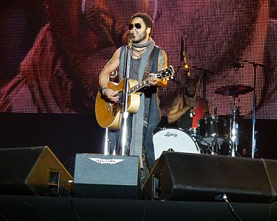 Which Lenny Kravitz album features the hit single "Fly Away"?