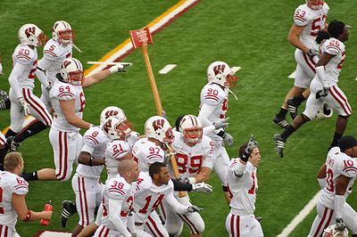 What conference does the Wisconsin Badgers football team compete in?