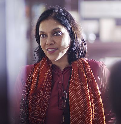 What is the main theme in many of Mira Nair's films?