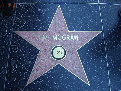 Which record company did Tim McGraw release 11 albums for?