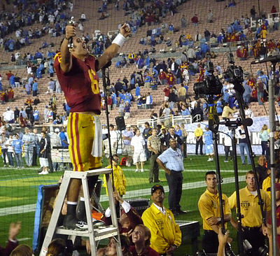 Who was the starting quarterback at USC that suffered injuries leading to Sanchez's rise?