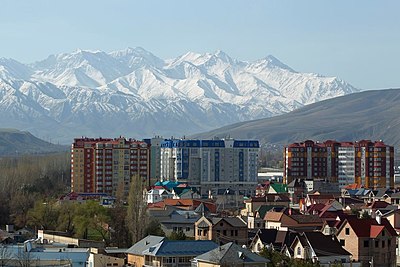 What type of landscape extends north of Bishkek into Kazakhstan?