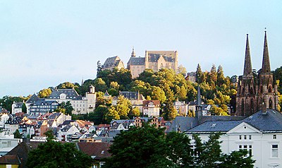 What is the name of the castle overlooking Marburg?