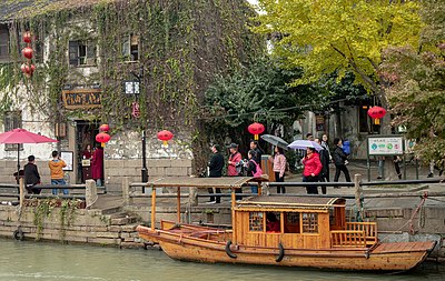 What is the primary language spoken in Suzhou?