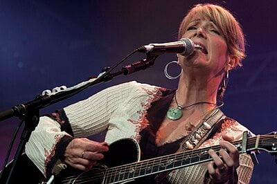 Kathy Mattea's style also includes which American roots music?
