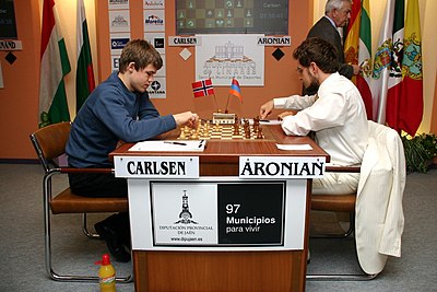 Which player did Carlsen defeat to become World Chess Champion in 2013?