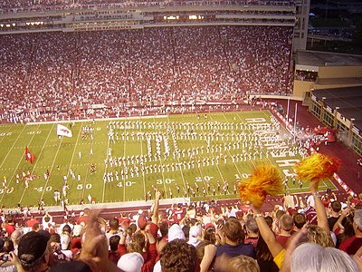 Which conference does the Arkansas Razorbacks football team compete in?