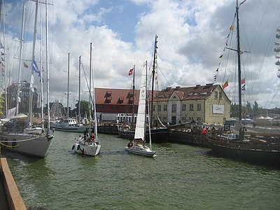 Which popular seaside resort is located to the north of Klaipėda?