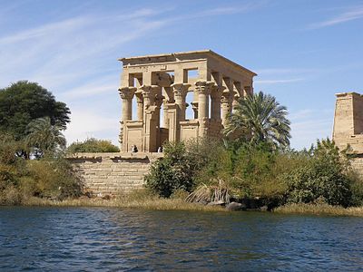 Which island was once a separate community but is now part of Aswan?