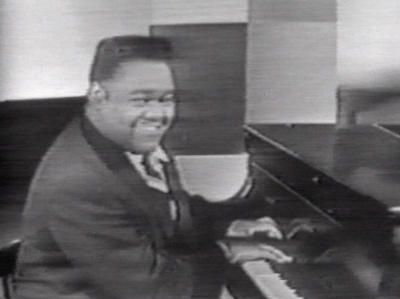 Which Fats Domino song did Lloyd Price also use his piano style in?