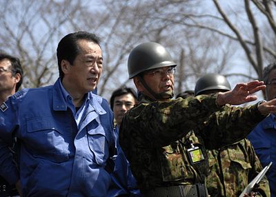 Did Naoto Kan resign as Prime Minister before or after his announcement in August 2011?
