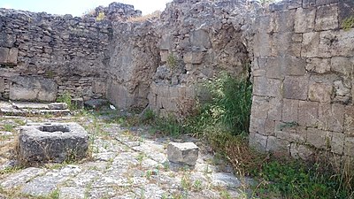 What is the modern name for the headland where Ugarit's ruins lie?