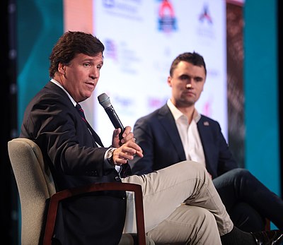 What type of political commentator is Tucker Carlson often described as?