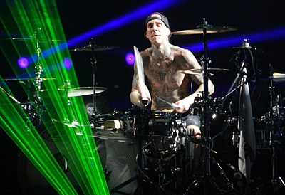 Which rock band did Travis Barker join in 1998?