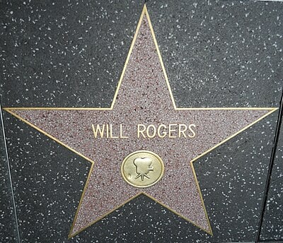 As a humorist, how many times did Will Rogers travel around the globe?