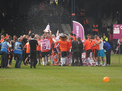 What year did Luton Town F.C. rejoin the Football League after leaving due to financial problems?