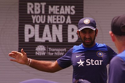 In which year did Pujara score his twelfth double-century in first-class cricket?