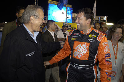 What type of racing cars did Tony Stewart win titles in before joining NASCAR?