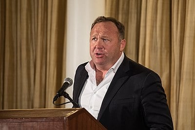 What is the alleged global conspiracy that Alex Jones claims governments and big businesses are colluding to create?