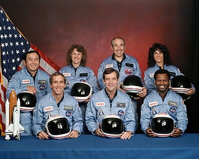 In 1986, McAuliffe was supposed to become the first ___ to fly in space.