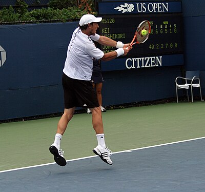 Juan Mónaco primarily excelled in which type of tennis?