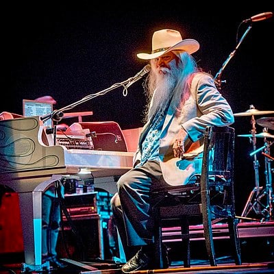 Which tour did Leon Russell organize and perform with Joe Cocker?