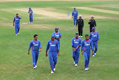 Who was the coach of the Afghanistan national cricket team when they gained Test status in 2017?