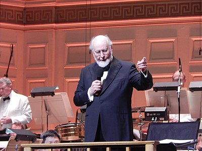 What position does John Williams currently hold with the Boston Pops?