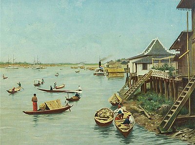 Which river island in Palembang is famous for its traditional stilt houses?