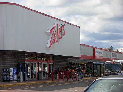 How many Zellers stores were operating at the time of its acquisition by Hudson's Bay Company?
