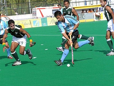 Who is the former captain of the Pakistan men's national field hockey team who holds the World Record for the most international goals scored?