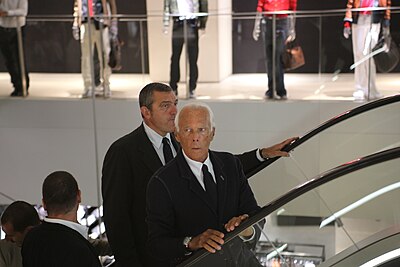 Which fashion brand did Giorgio Armani first gain notoriety working for?