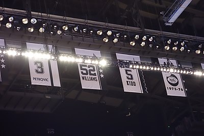 Which year did Petrović's number get retired by the Nets?