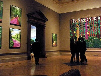 Besides painting, what other medium is Hockney famous for?