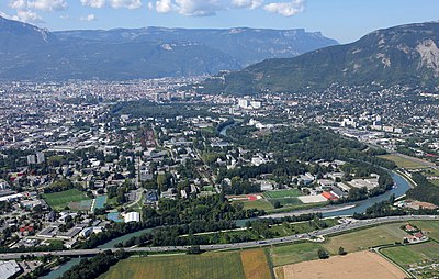 Which river flows into the Isère at Grenoble?