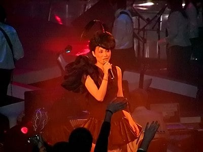 Besides Final Fantasy VIII's "Eyes on Me," Faye Wong recorded few songs in what language?