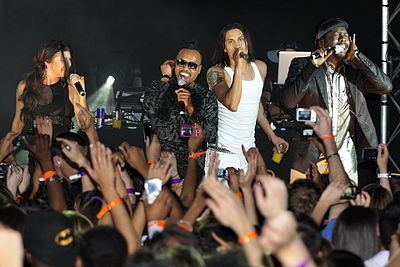What language does Apl.de.ap often incorporate into his music?