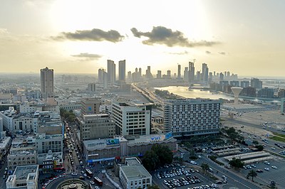 What is the relationship between Manama and Muharraq?