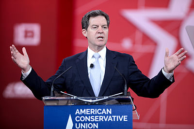 What is Sam Brownback's profession?