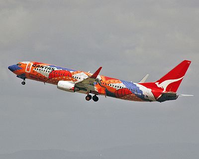 Which Australian city was the first destination for Qantas international passenger flights?