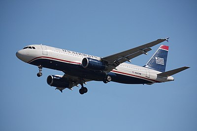 Which airline carried out a reverse merger with US Airways in 2005?