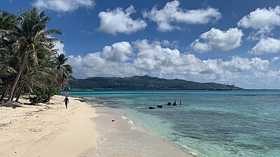What is the name of the popular beach on the western side of Saipan?