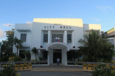 How far is Surigao City from the Visayas region across the Surigao Strait?