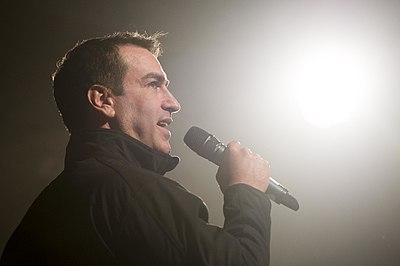 Which comedian did Rob Riggle co-host a television show with?
