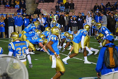 Which former UCLA Bruins player holds the record for most rushing yards in a single season?