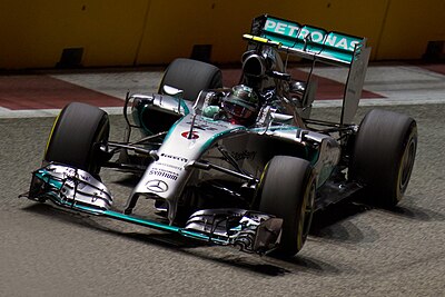 Which team did Nico Rosberg drive for when he won his first Formula One race?