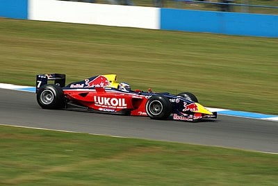 Which former Carlin driver won the 2010 F1 World Championship?